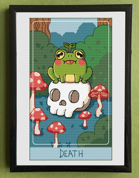 Framed artwork of a cartoon frog on a skull with mushrooms, titled 'Death', against a green wall.