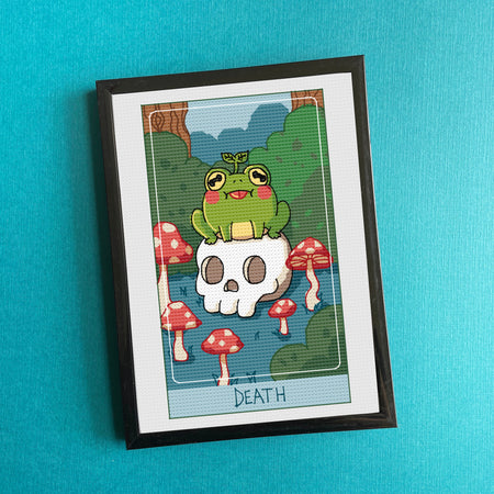 Framed artwork with a cartoon frog on a skull and mushrooms against a blue background