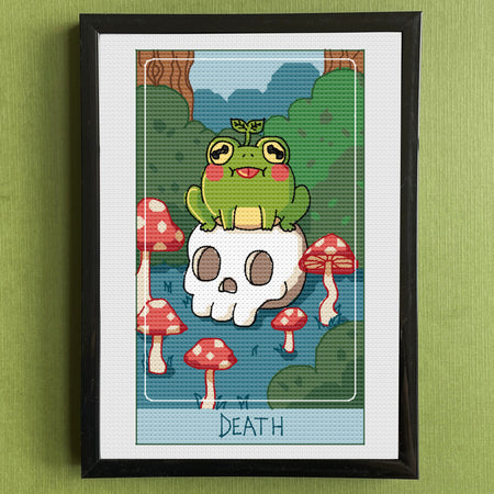Framed artwork of a cartoon frog on a skull with mushrooms, titled 'Death', against a green wall.