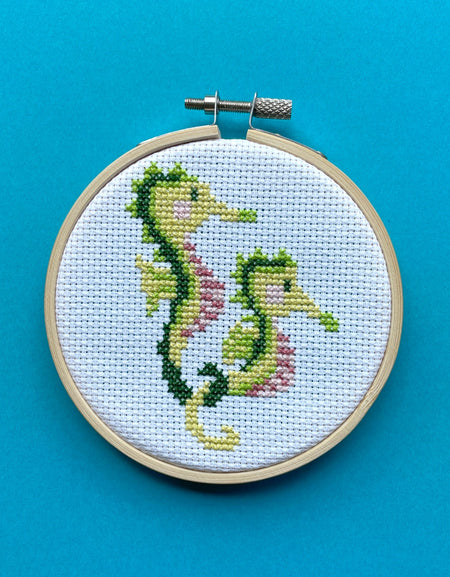 Embroidery hoop with a seahorse design on a blue background
