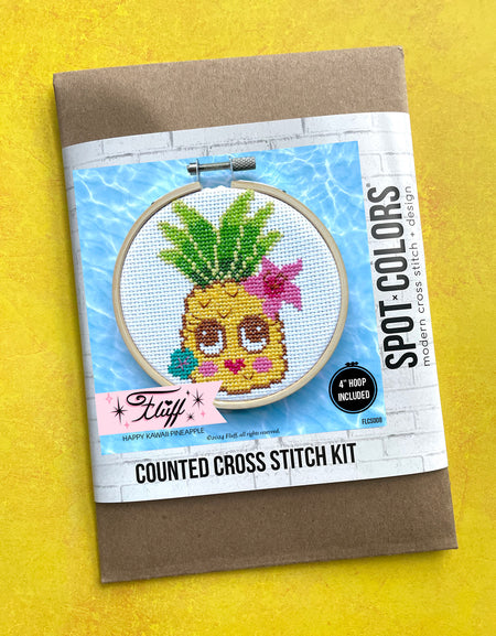 Cross stitch kit with pineapple design on a yellow background