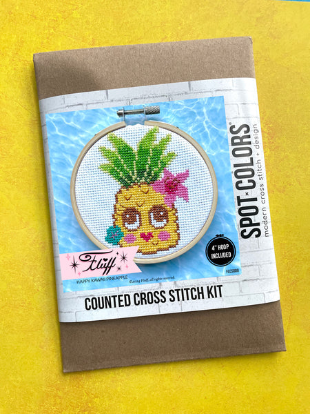 Cross stitch kit with pineapple design on a yellow background