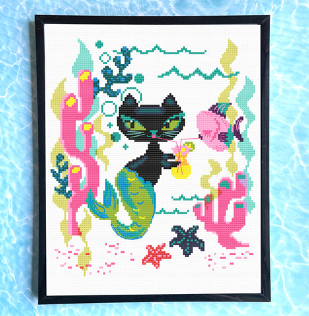 Cross-stitched design of a black cat mermaid with colorful sea-themed elements on a white background.