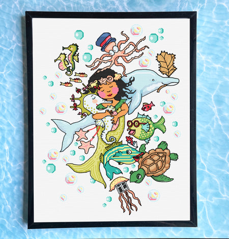 Framed artwork of a mermaid surrounded by sea creatures on a blue watercolor background.